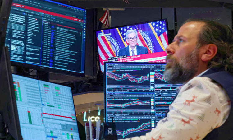 Divided Fed lowers  rates, signals pause